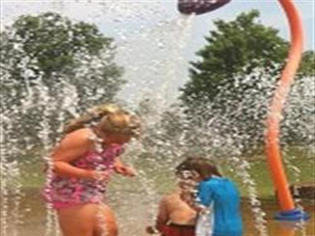 Children laughing and playing in a water park